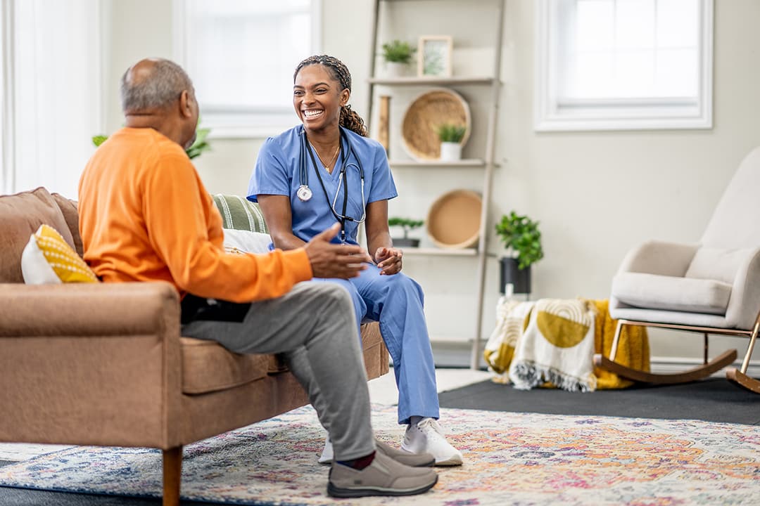 Caretaker with elderly man in home