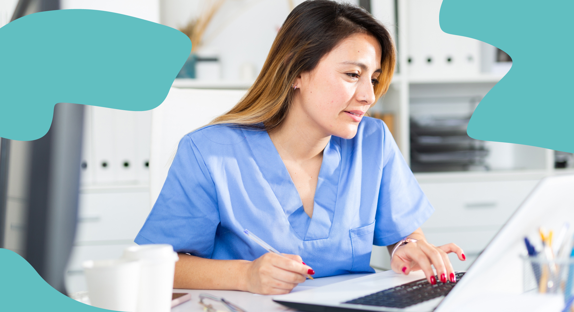 Nurse in blue uniform typing on a laptop