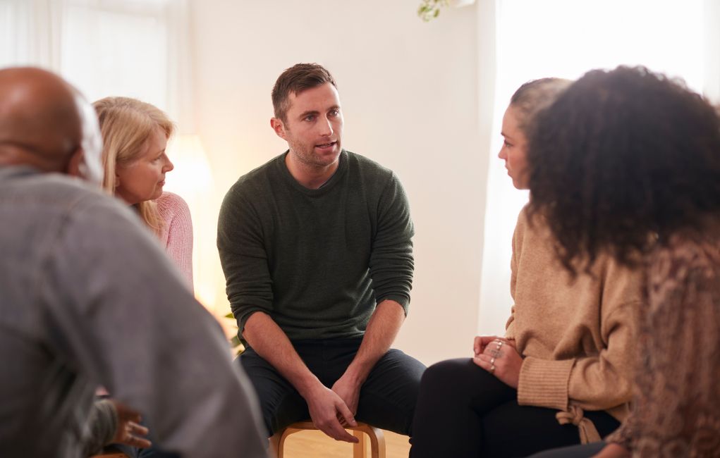 Man speaking at during a group therapy session