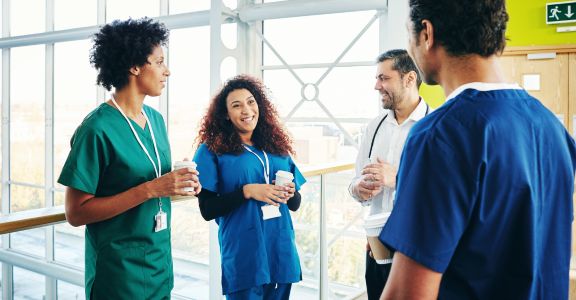 group of nurses and CNAs talking