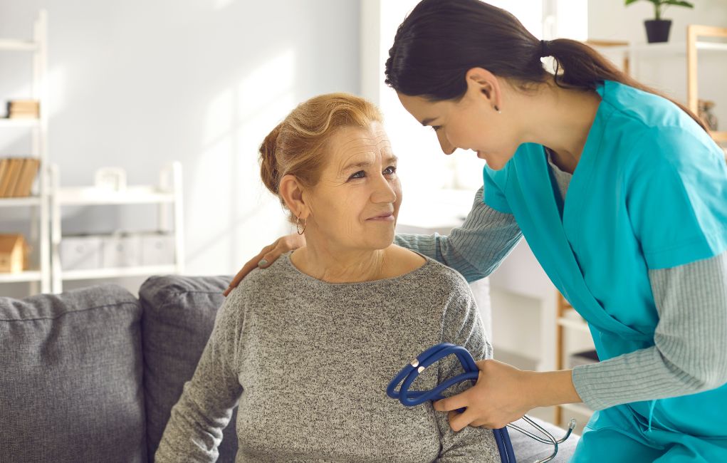 Nurse taking care of an elderly woman at home