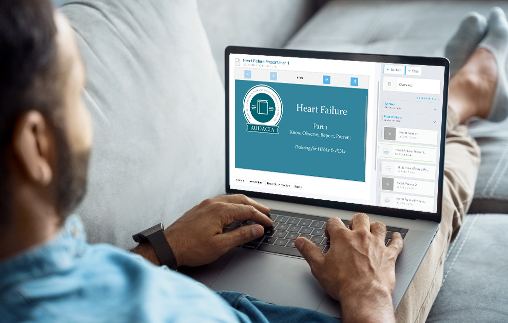 Man on laptop at home reading a presentation about heart failure as part of in-service training